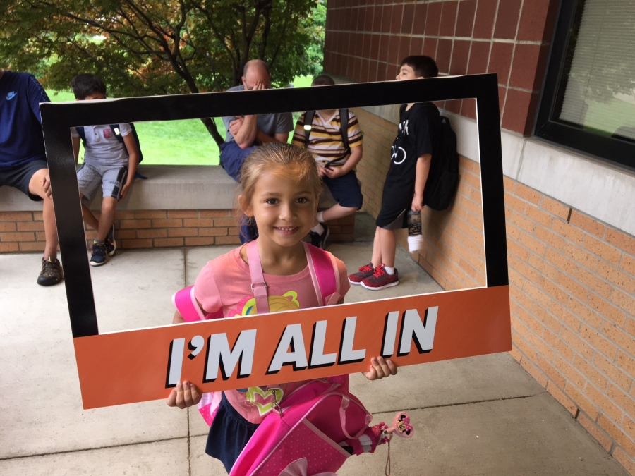 people holding a frame sign